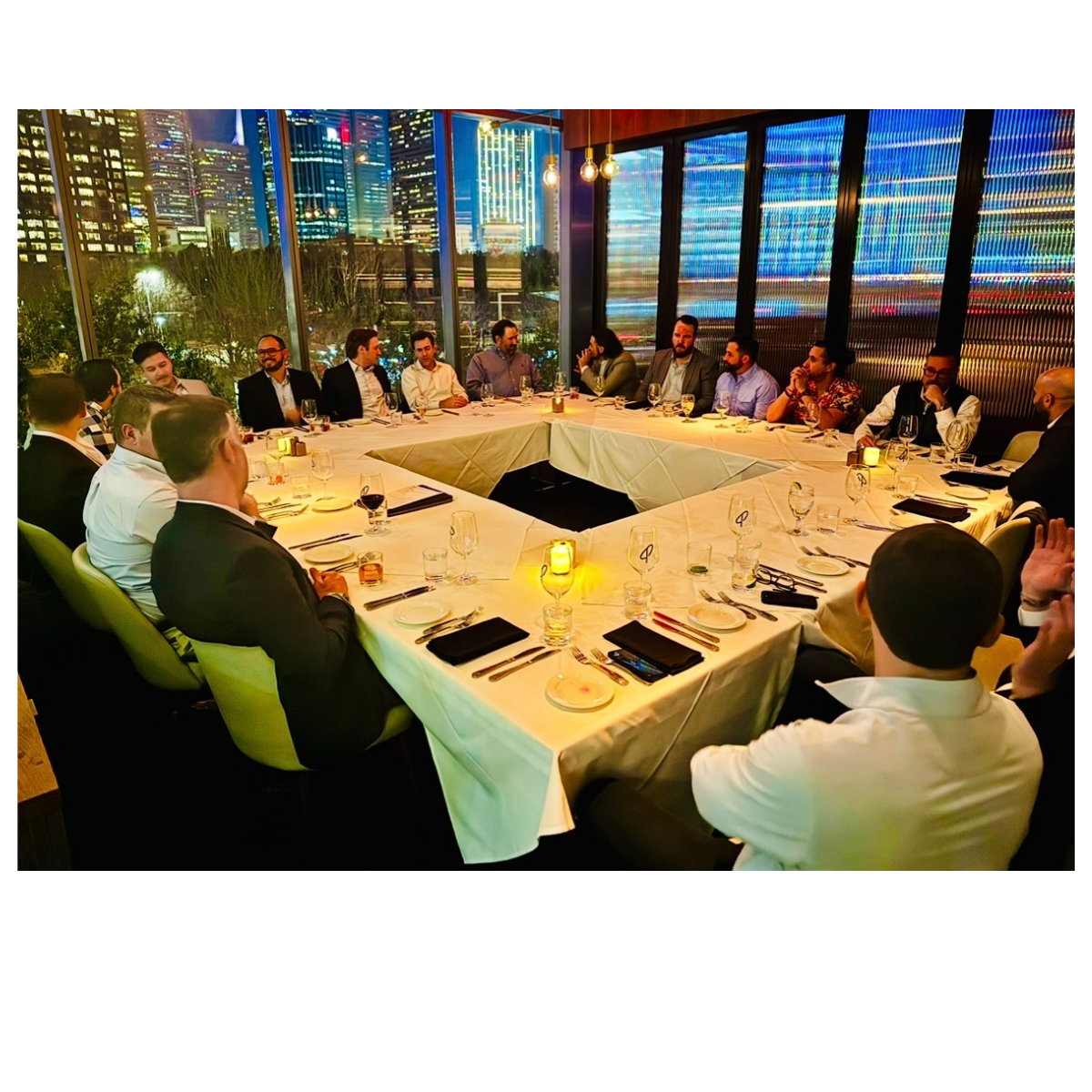 Private evening roundtable dinner with skyline views through the windows