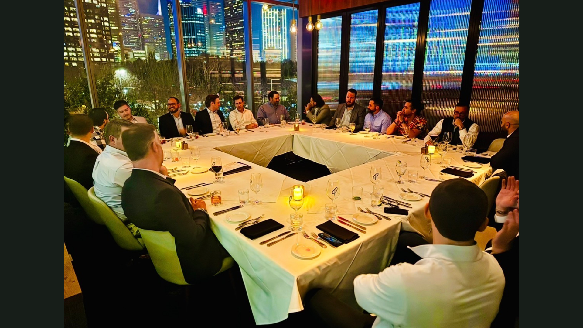 U-shaped roundtable mid-conversation with Dallas skyline behind